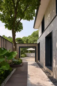 A traditional house with a stone exterior, featuring a patio area with chairs and a dining table
