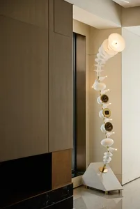 An arrangement of white ceramic vases in various shapes and sizes on a table, showcasing intricate details and creative composition