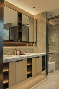 Modern bathroom with a wooden vanity, sink, toilet, and mirror, featuring clean lines and minimalistic elements
