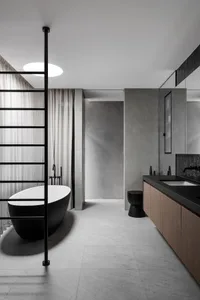 Modern bathroom with a black marble bathtub, wooden sink, and two sinks, featuring a sleek and contemporary design with a focus on functionality and luxury