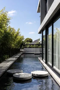An indoor swimming pool surrounded by black iron fencing, with benches and a calm atmosphere