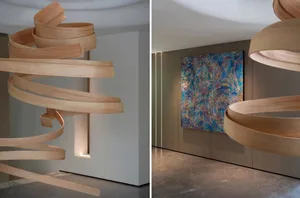 A modern art installation in a white room with wooden elements in one view and empty space in the other, creating a minimalist and clean atmosphere