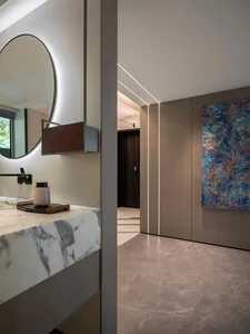 Modern bathroom with a large mirror, sink, and doorway, well-lit by natural sunlight