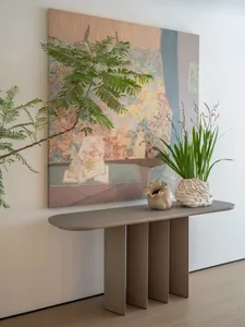 A cozy living area with a wooden table, decorative items, vases, potted plants, and a book