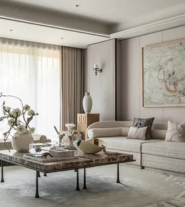 Elegant living room with a large couch, coffee table, vases, potted plants, and a dining table, set in a well-lit space