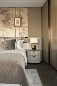 Cozy bedroom with a large bed, two lamps, and a brown wooden headboard, set in a modern and inviting space
