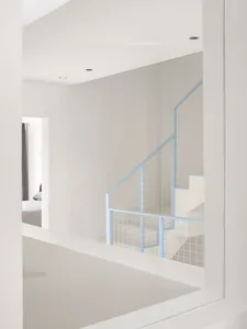 A minimalist staircase with metal steps, set against a blank background, conveying a sense of simplicity and elegance