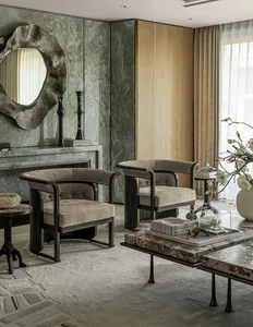 A modern living room with a fireplace as the focal point, surrounded by couches and chairs, in a dimly lit space with neutral tones and clean lines