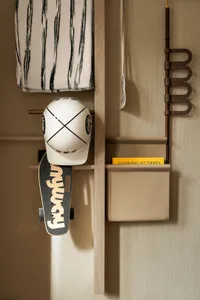 A well-organized storage area with wooden shelves, featuring books, skateboards, and hats, with a functional and organized appearance
