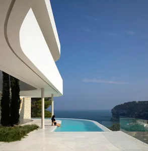 A modern building with a swimming pool and clean lines, surrounded by a relaxing and luxurious environment
