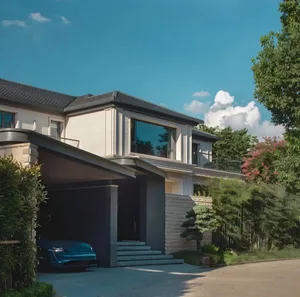 A modern house with a gray exterior, black roof, and a garage with two parked cars, set in a calm and serene atmosphere