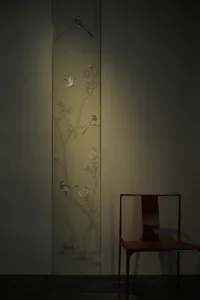 A colorful wall art featuring three birds perched in trees, creating a sense of depth and dimension