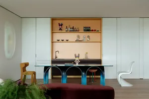 Cozy dining area with a wooden table and chairs, decorative vases, and various items on the table