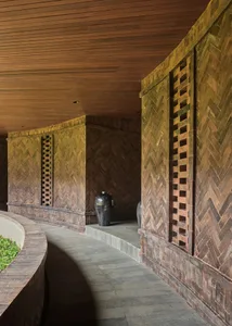 Warm and inviting living space with wooden walls and ceiling, decorated with vases and a blend of traditional and modern elements