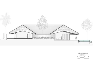 A tranquil modern house with a sloping roof and a large tree in its courtyard