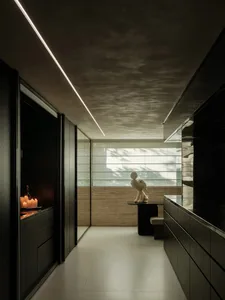 Sophisticated kitchen with a black countertop, white floor, and two statues, a sink, and a well-designed atmosphere