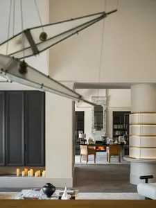 Cozy open concept living space with a dining table, chairs, and scattered books, featuring a warm and inviting atmosphere