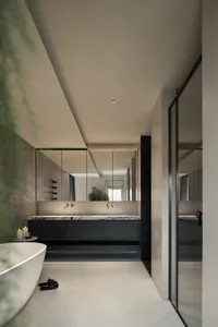 Modern bathroom with a large bathtub, two sinks, black cabinets, and white fixtures, creating a clean and well-organized atmosphere