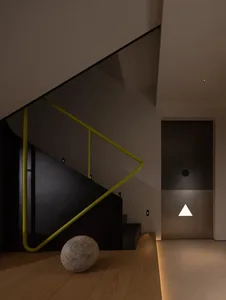 A perspective view of a staircase with wooden steps and a doorway at the bottom, suggesting depth and dimension