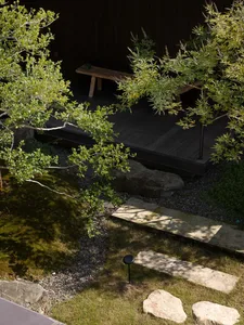 Wooden patio with a dining table and two benches, surrounded by a relaxed and inviting atmosphere