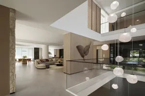 Open living area with a couch, chairs, dining table, potted plants, and vase, surrounded by natural light and modern decor