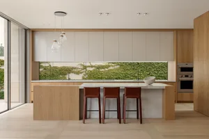 Warm and inviting kitchen space with wooden cabinets and countertops, featuring a dining table and chairs