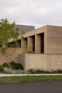 A rendered image of a brick building with a large window and trees in the foreground, set in an urban environment