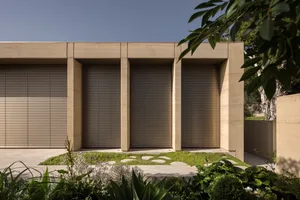 Modern building with large windows, concrete, glass, and wood materials, featuring ample natural light and a functional design