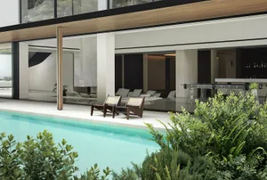 A well-lit indoor pool area with various chairs and a relaxing atmosphere