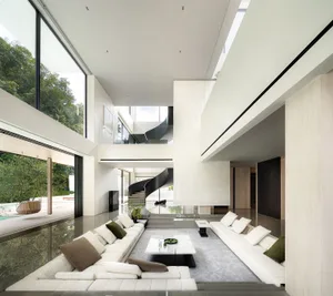 Open modern living area with a white couch, hardwood floor, multiple chairs, potted plants, a dining table, and a vase, in a bright and inviting atmosphere