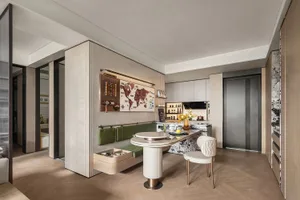 Cozy open concept living area with furniture, bottles, and cups, featuring a focus on functionality and comfort