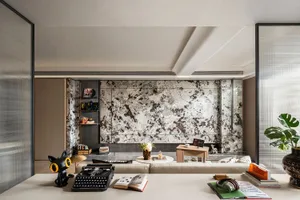 Cozy living space with a couch, dining table, bookshelf, and decorative elements, well-lit by natural sunlight