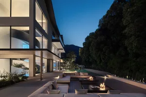 A modern house with a pool area featuring comfortable seating and a relaxing atmosphere