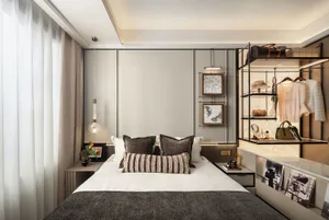 A cozy bedroom with a large bed, bookshelf, and decorative pictures, featuring a handbag near the foot of the bed