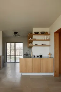 Modern kitchen with wooden cabinets, countertops, and various kitchenware, creating a warm and inviting atmosphere