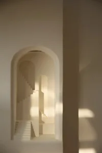 A stone staircase in a church, illuminated by sunlight, with warm shadows and a sense of history