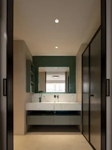 Modern bathroom with two sinks, white walls, and black cabinets, featuring ample reflection from two mirrors