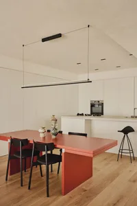 Warm and inviting dining space with a wooden table and black metal chairs