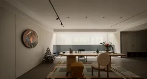 Empty living room with a large window, two chairs, a dining table, and vases and bowls, flooded with natural light