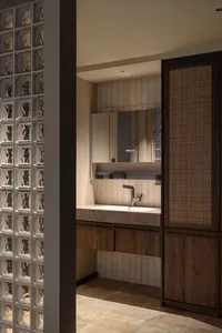 Modern bathroom with a sink, mirror, and wooden cabinetry, featuring clean lines and minimalistic design elements, with bright and airy ambiance