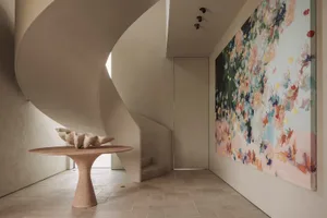 A minimalist spiral staircase in a home, with a top-down view and no other objects or elements present