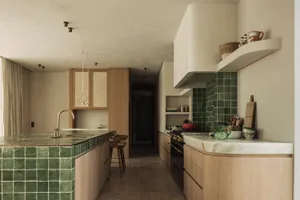 Warm and inviting kitchen with wooden cabinets, appliances, and a dining area
