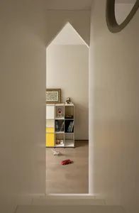 Cozy child's bedroom with a wooden floor, toys, books, and a teddy bear, creating a playful and inviting atmosphere