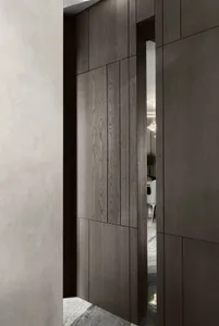 A warm and inviting home entrance with a wooden doorway leading to a dining area with a table and chairs