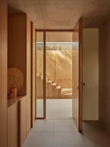 A warm and inviting home entrance with a wooden staircase and doorway