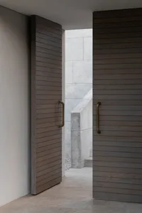 A real photo of a hallway with a stone wall, no furniture or decorations