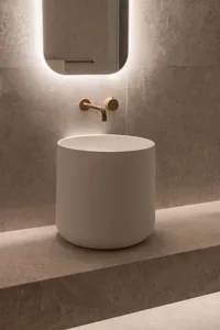 Modern bathroom with a marble bathtub, stone countertop, and a mirror above the sink area