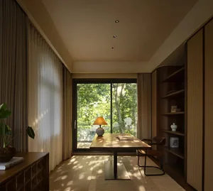 Open living area with wooden floor, neutral tones, and natural light from a large window