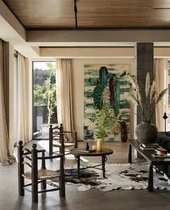 Open living space with wooden furniture, a dining table, and natural light from windows