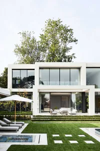 A modern living area with a patio featuring multiple seating options, clean lines, and a focus on functionality and comfort